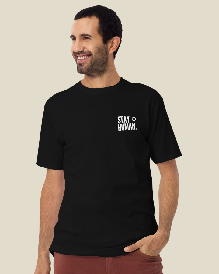 Stay Human Premium Tee in Black: the chest lockup on the left chest.