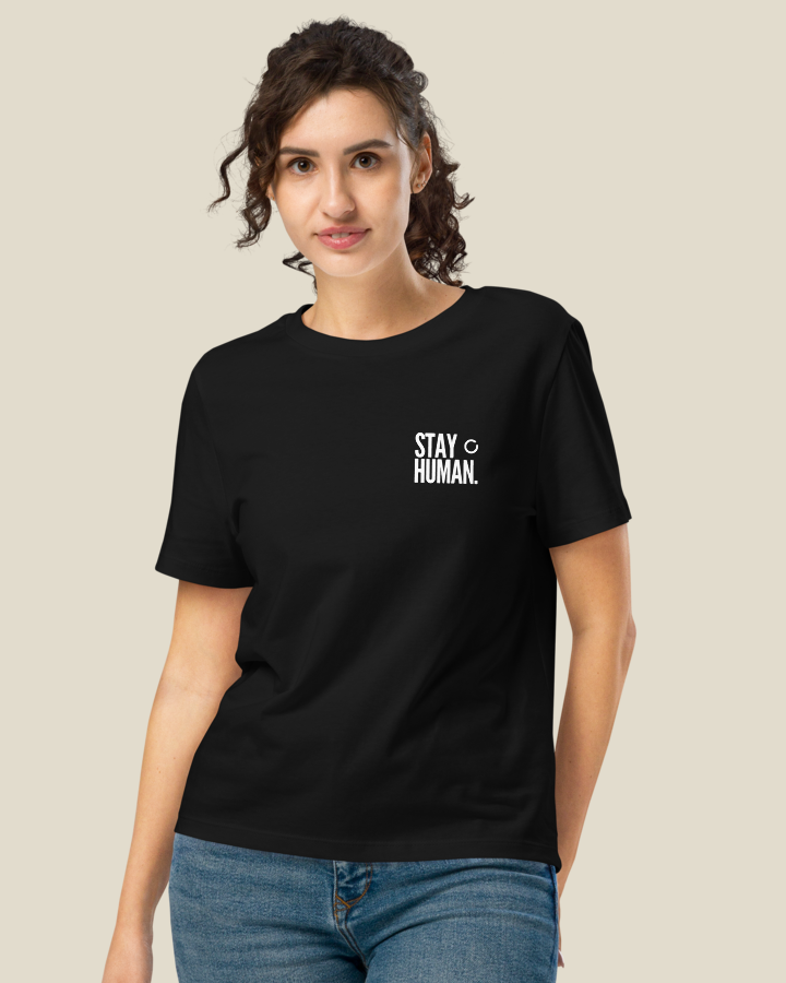 Close view of the STAY HUMAN statement printed on the left chest of the Women's fit shirt, in Black.